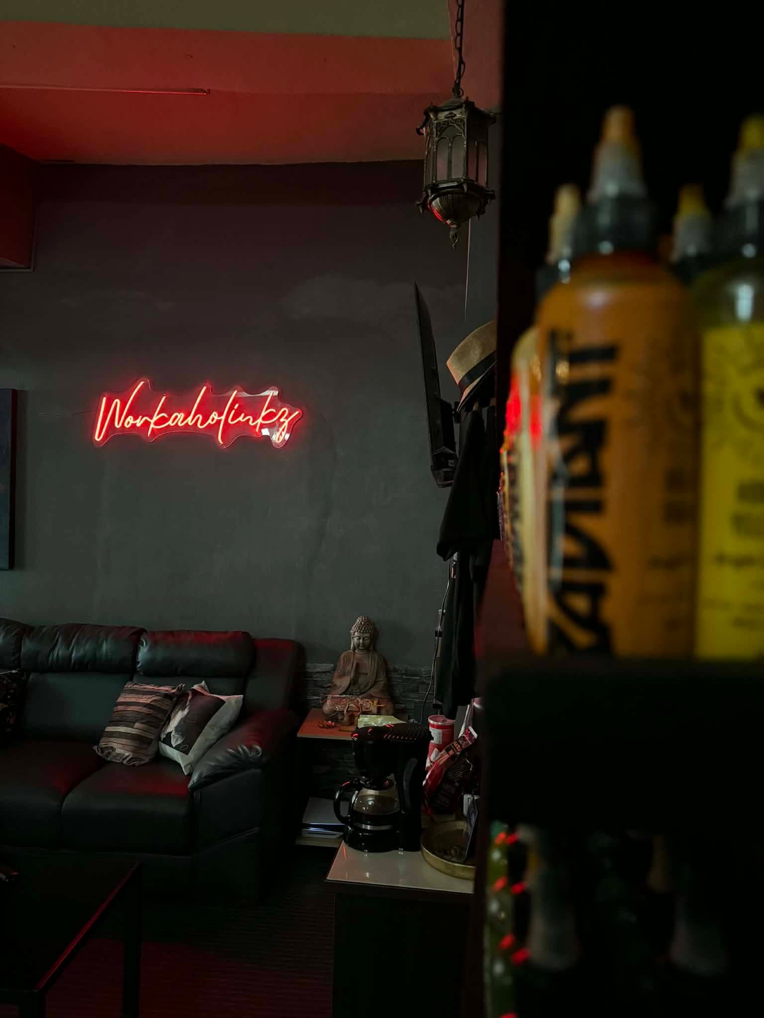 Close-up of tattoo ink bottles with the studio lounge in the background